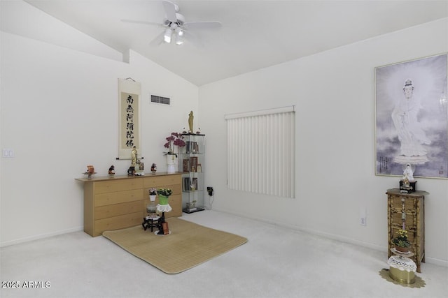 interior space with visible vents, baseboards, vaulted ceiling, carpet flooring, and a ceiling fan