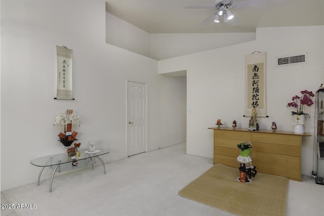 unfurnished room with lofted ceiling, light colored carpet, visible vents, and ceiling fan