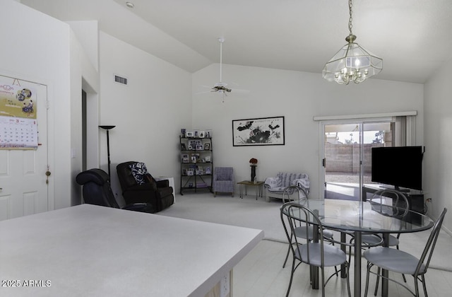 dining area with visible vents, a ceiling fan, and lofted ceiling