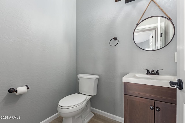 bathroom featuring hardwood / wood-style flooring, vanity, and toilet