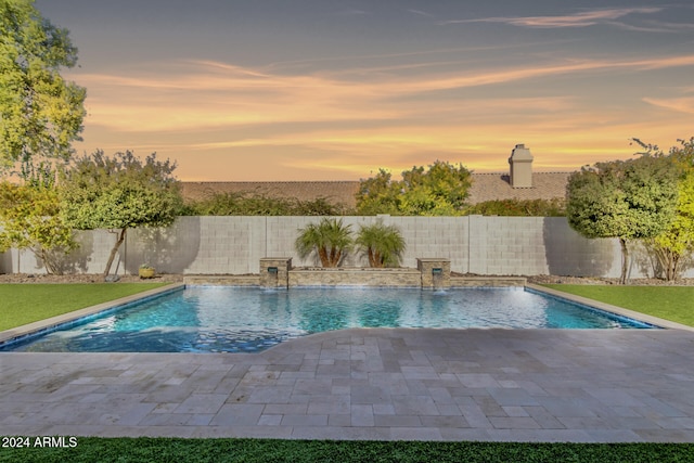 pool at dusk with pool water feature