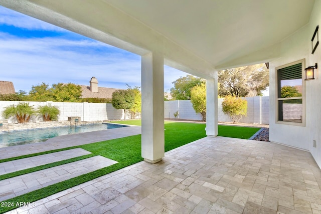 view of patio with a fenced in pool and pool water feature