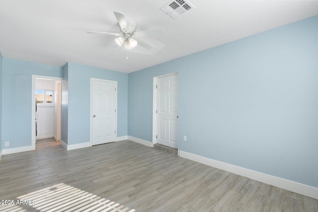 5011 S 20th Pl, Phoenix, AZ 85040 - unfurnished bedroom featuring light wood-style floors, baseboards, and a ceiling fan
