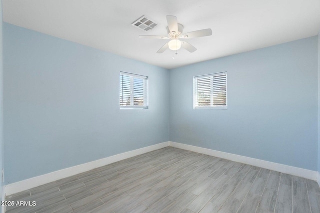 5011 S 20th Pl, Phoenix, AZ 85040 - empty room with light wood-style floors, a ceiling fan, and baseboards
