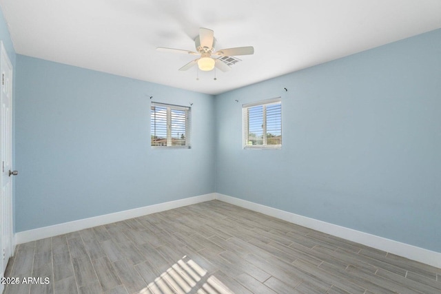 5011 S 20th Pl, Phoenix, AZ 85040 - spare room featuring wood tiled floors, ceiling fan, and baseboards