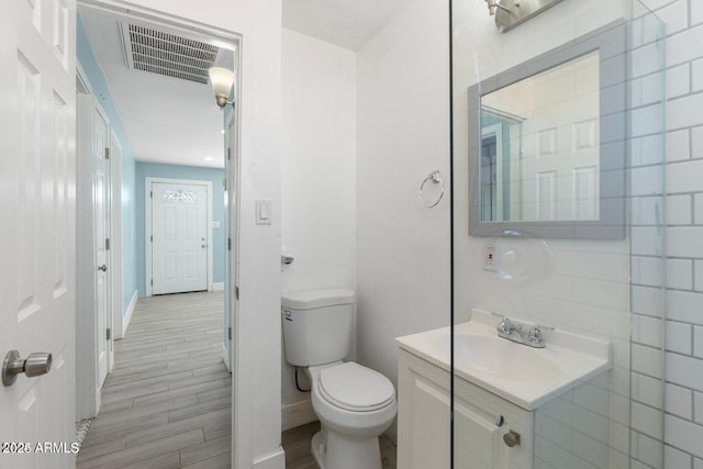 5011 S 20th Pl, Phoenix, AZ 85040 - bathroom featuring vanity, toilet, wood finished floors, and baseboards