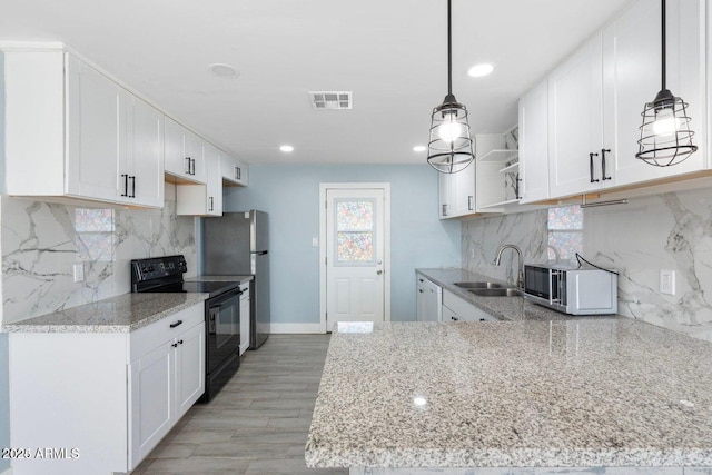5011 S 20th Pl, Phoenix, AZ 85040 - kitchen with appliances with stainless steel finishes, a sink, open shelves, light stone counters, and recessed lighting
