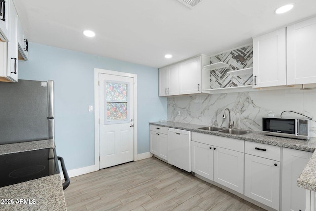 5011 S 20th Pl, Phoenix, AZ 85040 - kitchen with appliances with stainless steel finishes, open shelves, a sink, decorative backsplash, and white cabinets