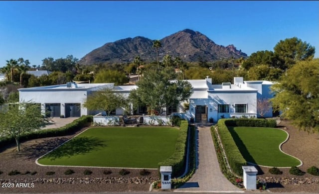 exterior space with a mountain view and a front lawn