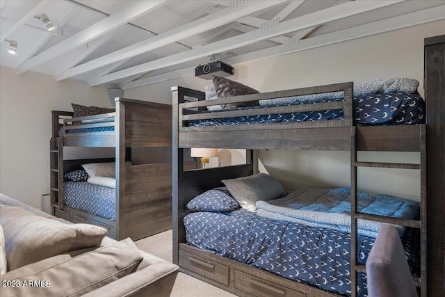 carpeted bedroom featuring vaulted ceiling with beams