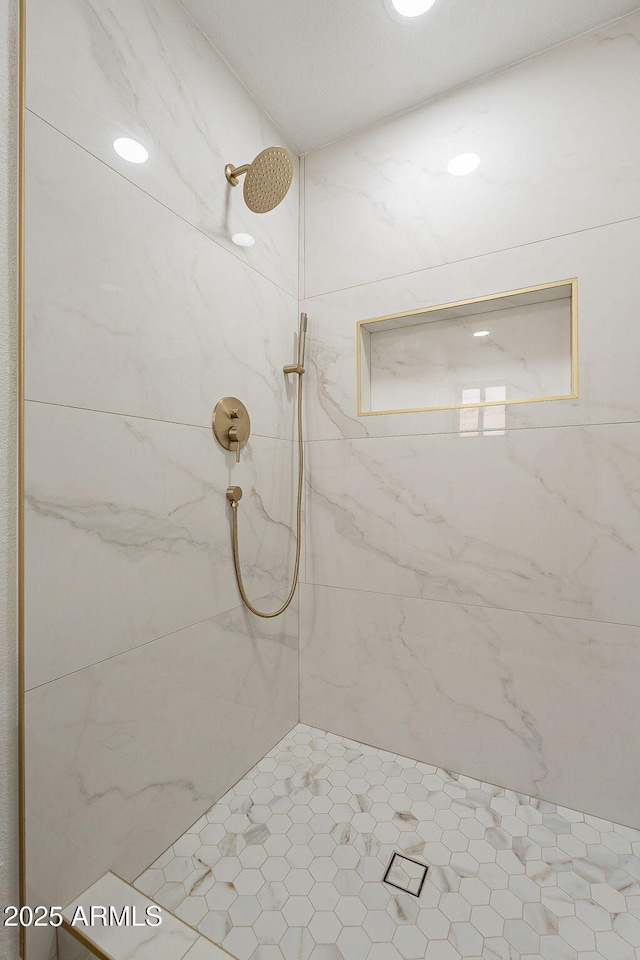 full bath featuring a tile shower