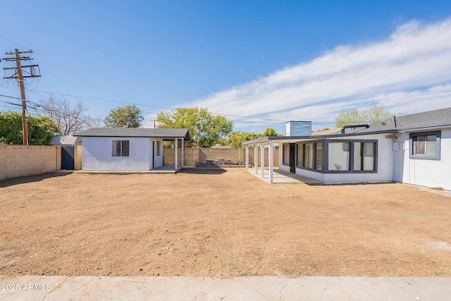 back of house with a patio, a fenced backyard, and stucco siding