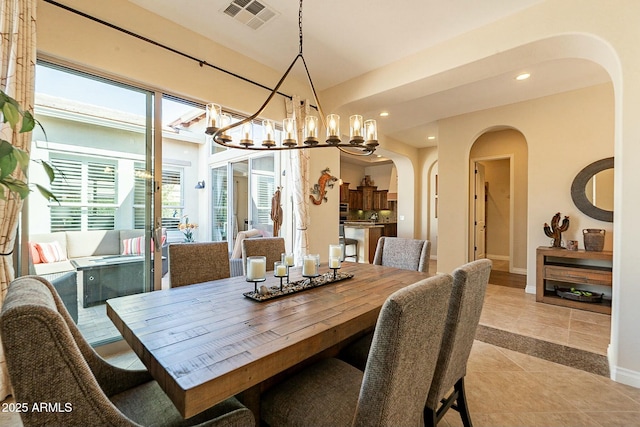 dining area with arched walkways, a chandelier, recessed lighting, visible vents, and baseboards