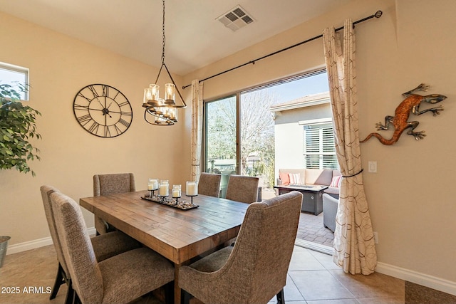 dining space featuring baseboards, visible vents, a notable chandelier, and light tile patterned flooring