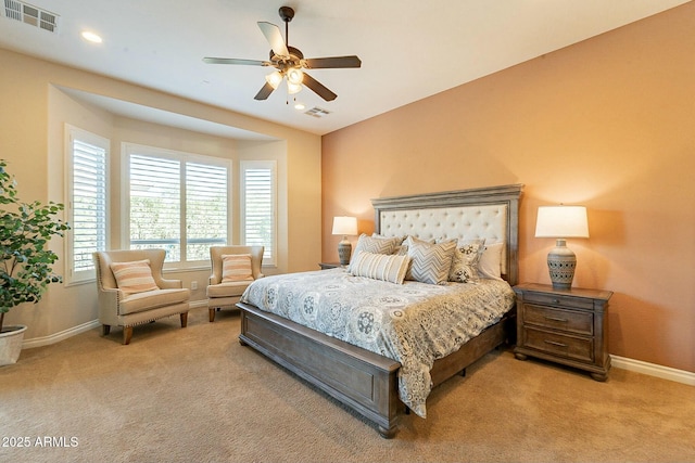 bedroom featuring baseboards, visible vents, and light colored carpet