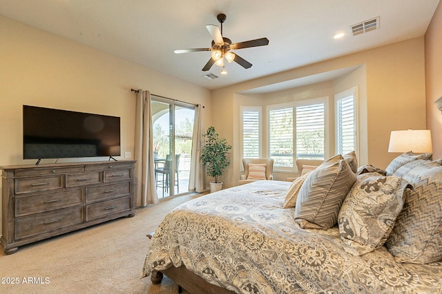 bedroom with light carpet, access to outside, visible vents, and ceiling fan