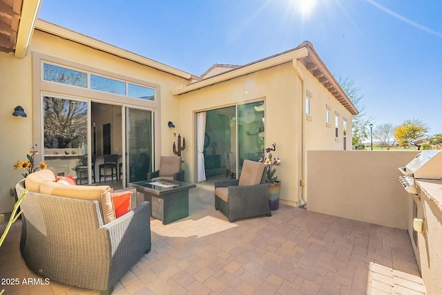 view of patio / terrace featuring an outdoor fire pit