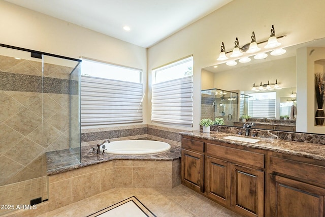 bathroom featuring a garden tub, a shower stall, tile patterned flooring, and vanity