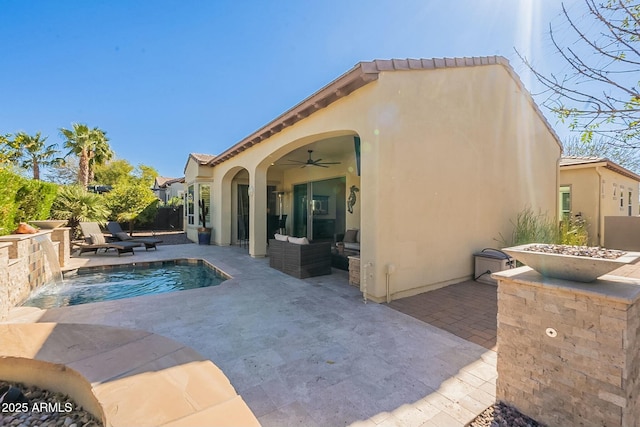 back of house with a patio area, ceiling fan, and stucco siding