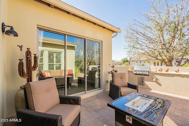 view of patio featuring outdoor lounge area, grilling area, and an outdoor kitchen