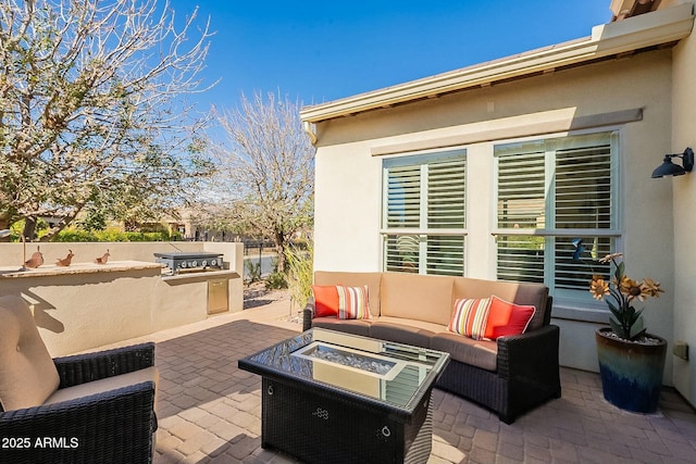 view of patio / terrace with exterior kitchen, fence, and an outdoor living space