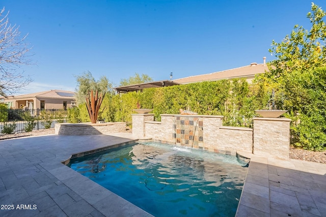 view of swimming pool featuring a patio area, fence, and a fenced in pool