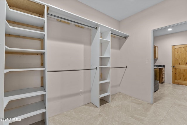 spacious closet with light tile patterned floors