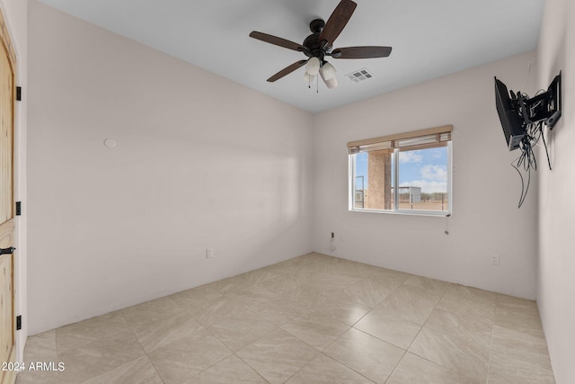 unfurnished room with light tile patterned flooring and ceiling fan