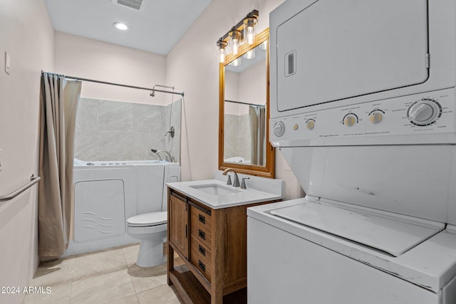 bathroom featuring vanity, stacked washer / dryer, tile patterned flooring, and toilet