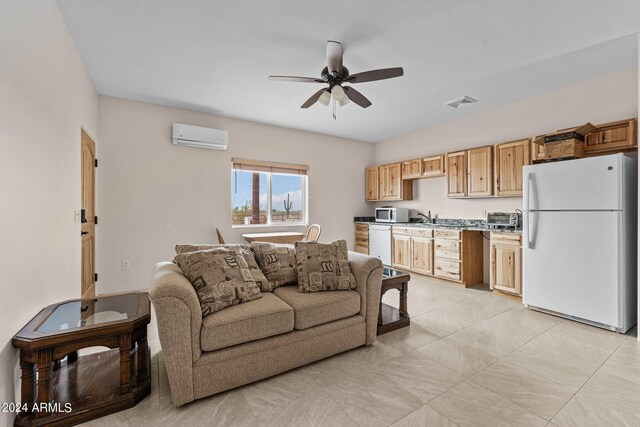 living room featuring a wall unit AC, sink, light tile patterned floors, and ceiling fan