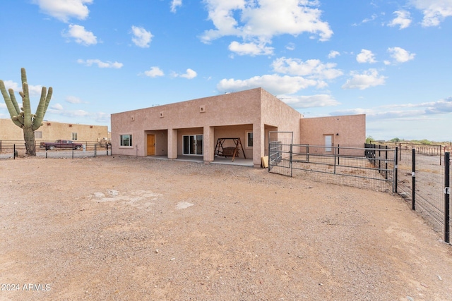 rear view of house featuring a patio