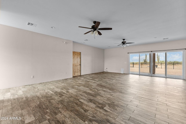 unfurnished room with ceiling fan and light wood-type flooring