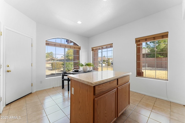 kitchen with light tile patterned flooring and a center island