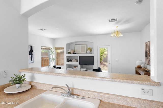 kitchen with plenty of natural light, sink, and pendant lighting