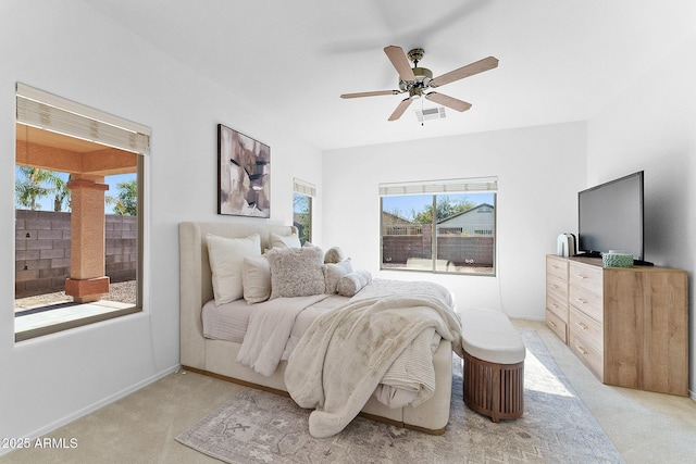 bedroom featuring light carpet and ceiling fan