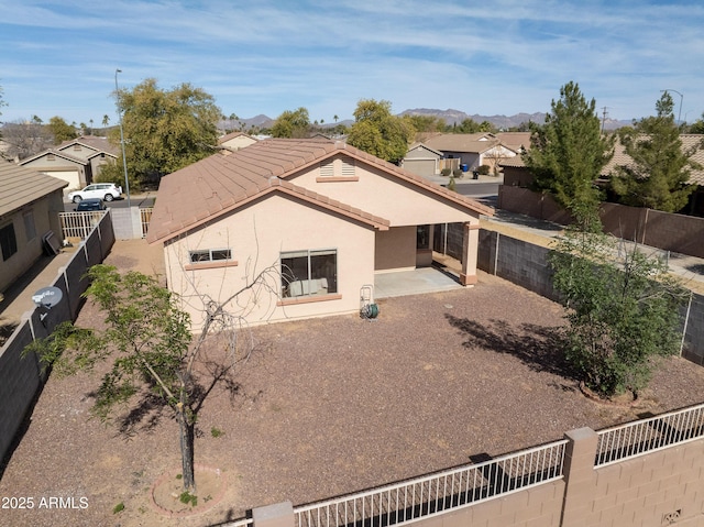 rear view of property featuring a patio area