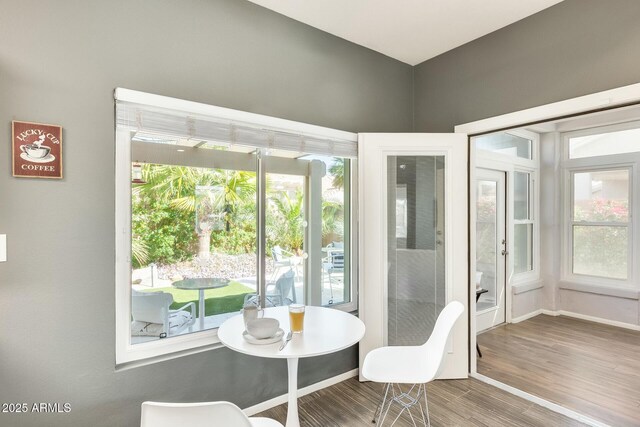 dining area with wood finished floors and baseboards