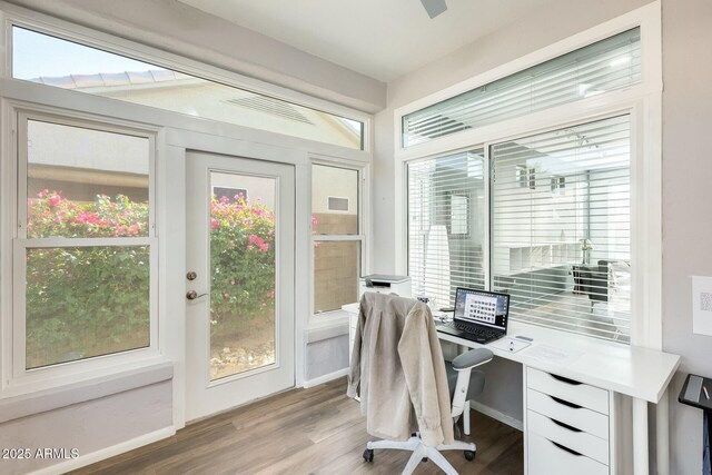 home office with light wood-type flooring and baseboards