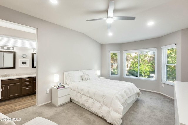 bedroom featuring connected bathroom, baseboards, vaulted ceiling, light carpet, and recessed lighting