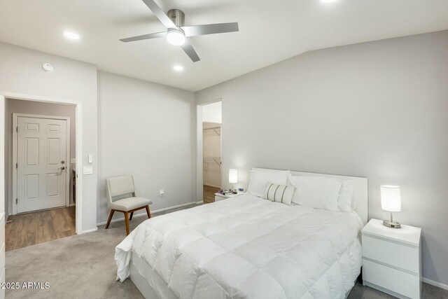 bedroom with baseboards, carpet floors, a ceiling fan, and a spacious closet