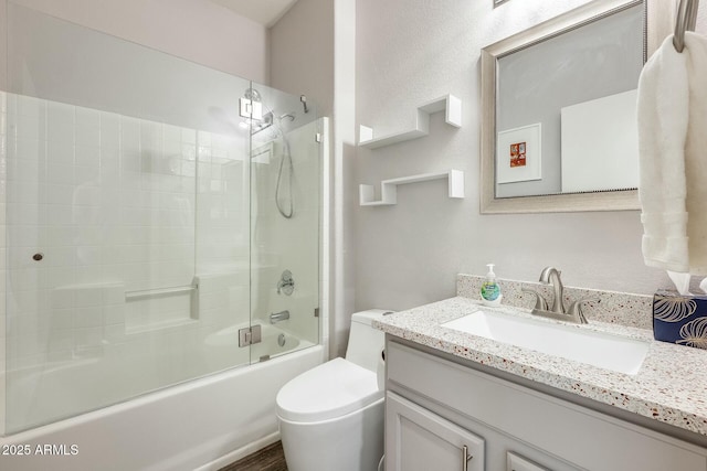 full bathroom featuring enclosed tub / shower combo, toilet, and vanity