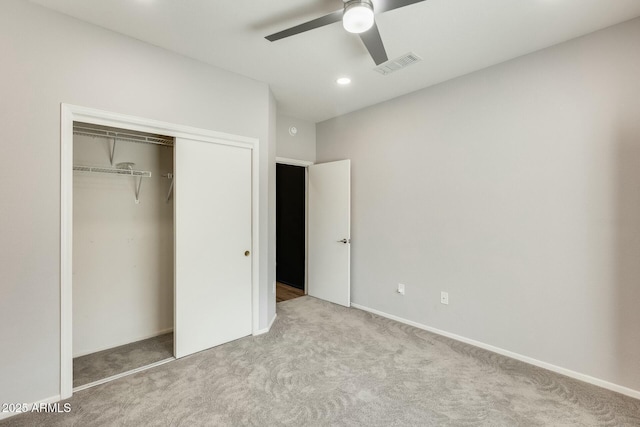 unfurnished bedroom featuring visible vents, a ceiling fan, a closet, and carpet flooring