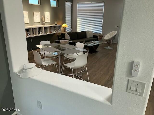 dining room with a textured wall and wood finished floors