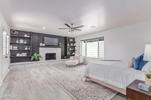 13012 N 36th Dr, Phoenix, AZ 85029 - bedroom with wood finished floors, a fireplace, a ceiling fan, and recessed lighting