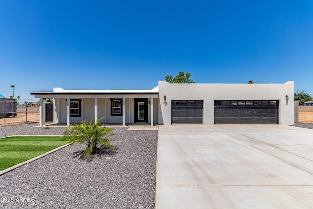 13012 N 36th Dr, Phoenix, AZ 85029 - view of front of property with covered porch, an attached garage, concrete driveway, and stucco siding