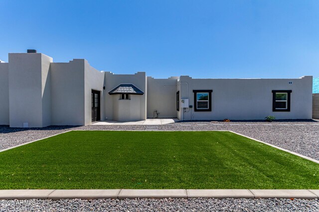 13012 N 36th Dr, Phoenix, AZ 85029 - pueblo-style home featuring a front lawn and stucco siding