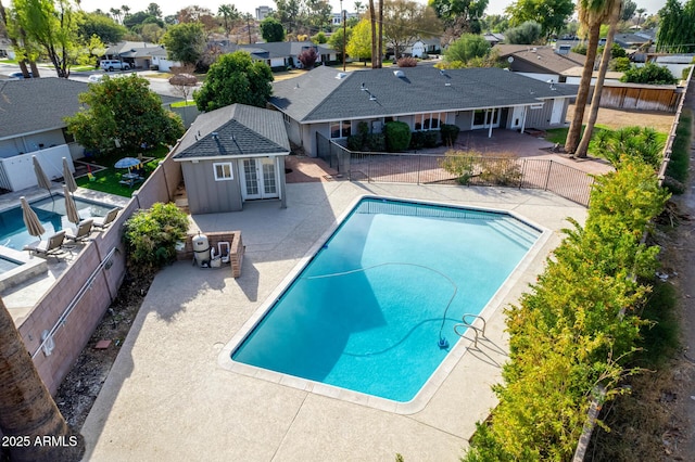 view of swimming pool featuring a patio area and an outdoor structure