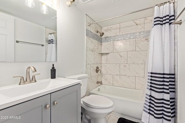 full bath with toilet, marble finish floor, shower / bath combo with shower curtain, and vanity