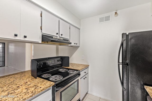 kitchen featuring under cabinet range hood, visible vents, white cabinets, stainless steel range with electric cooktop, and freestanding refrigerator