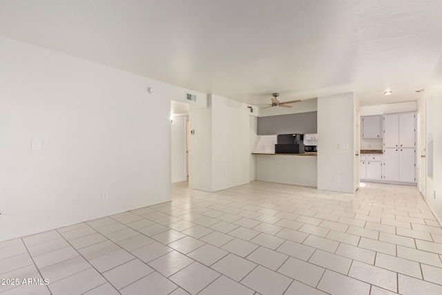 unfurnished living room featuring ceiling fan, light tile patterned flooring, and visible vents